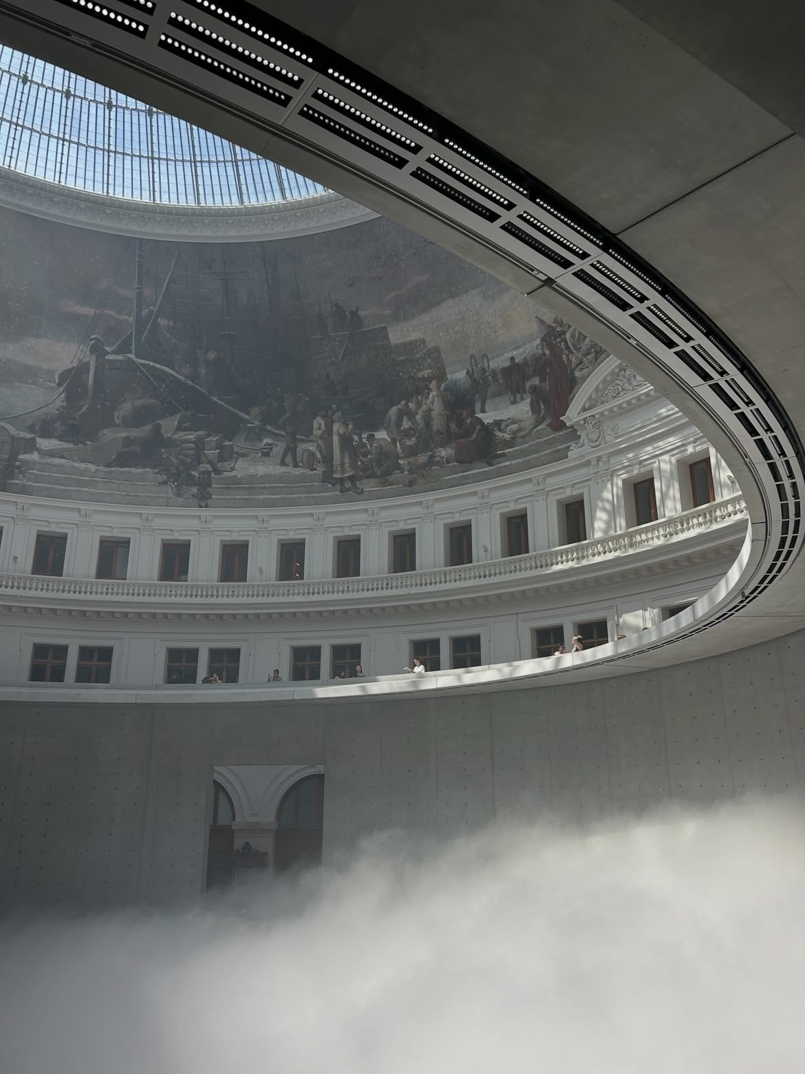 The Bourse de Commerce rotunda and dome are seen above a dense layer of fog.